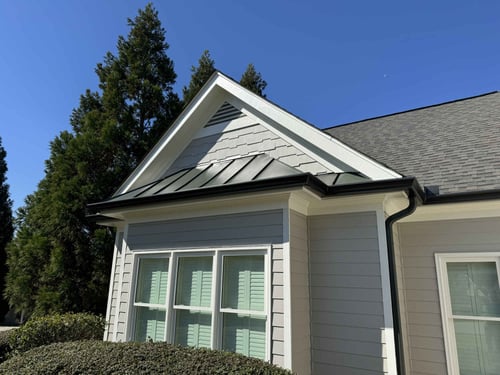 Exterior detail of light gray siding with new trim by Encompass Contracting in Athens, GA