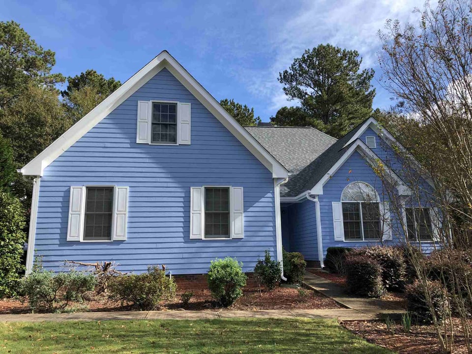 Front view of newly painted blue home by Encompass Contracting in Watkinsville, GA