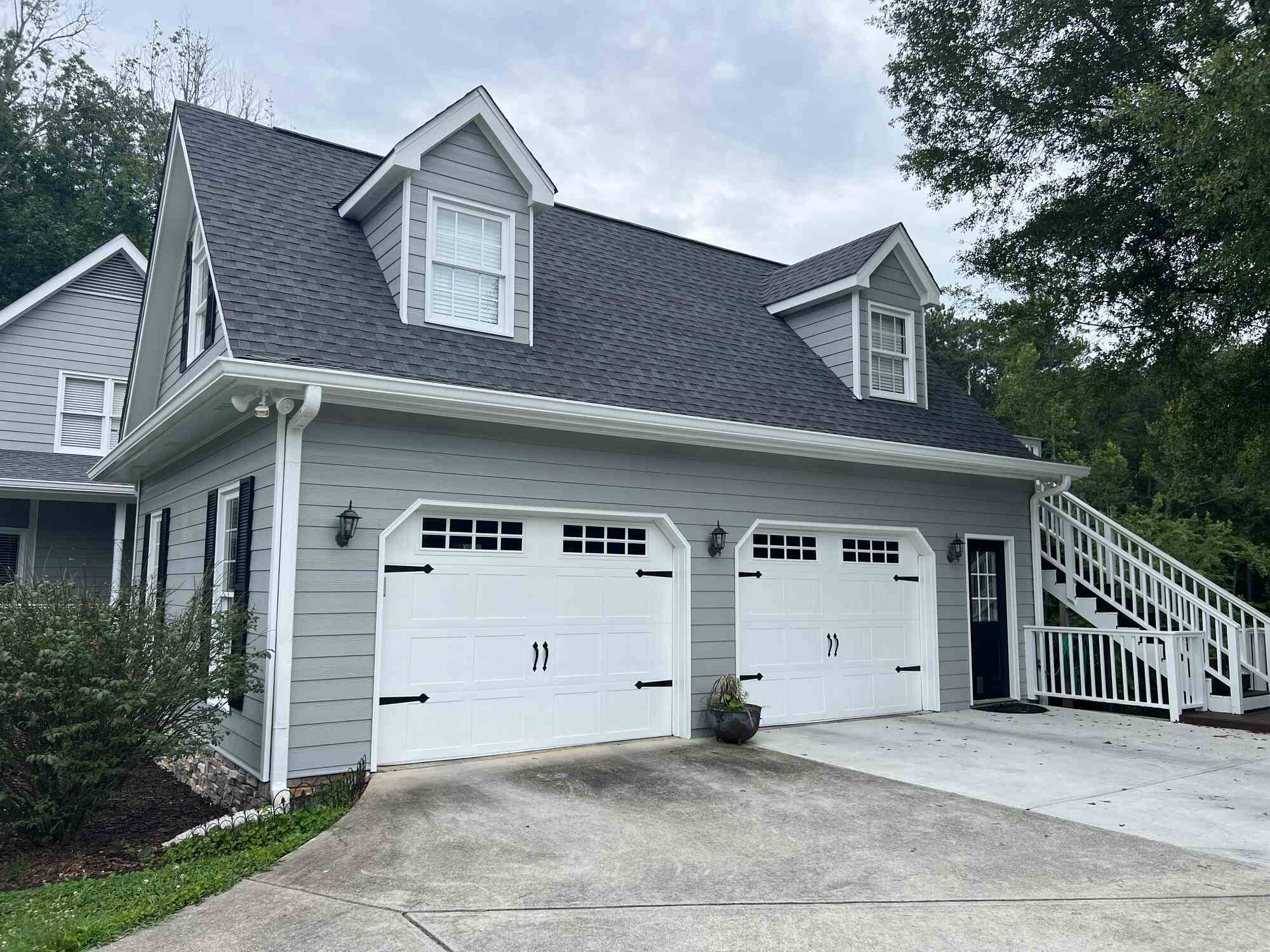 Garage repaint with gray siding and white trim by Encompass Contracting in Watkinsville, GA