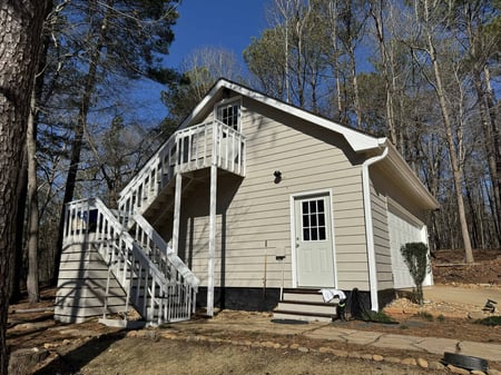 Garage exterior repaint with beige siding by Encompass Contracting in Statham, GA