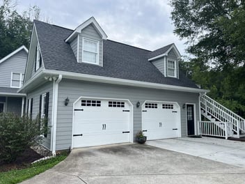 Garage repaint with gray siding and white trim by Encompass Contracting in Watkinsville, GA