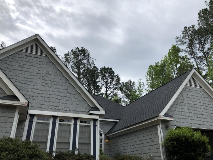 Gray exterior home with new roofing in Statham, GA by Encompass Contracting