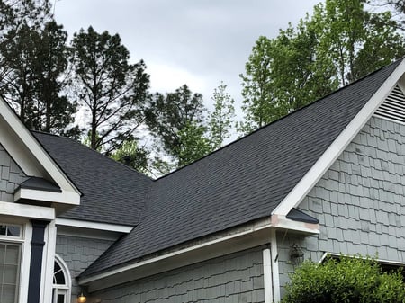 Roofing replacement detail on gray house in Watkinsville, GA by Encompass Contracting