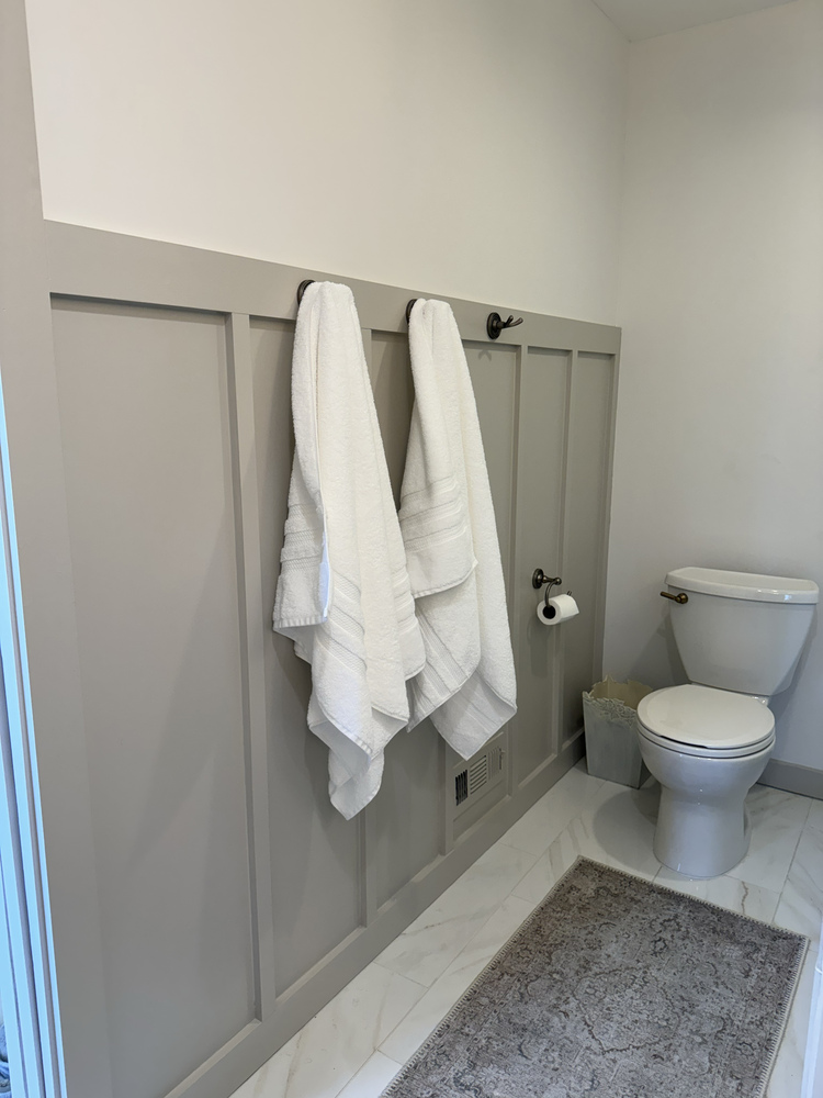 Bathroom remodel in Watkinsville, Georgia by Encompass Contracting showcasing board and batten wall detail and towel hooks