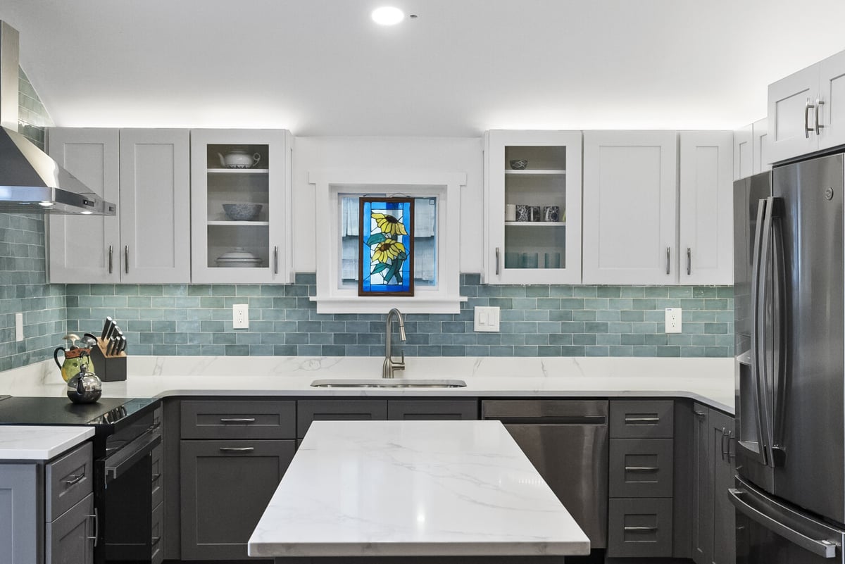 Full kitchen remodel with stained-glass window and teal backsplash by Encompass Contracting in Watkinsville, GA