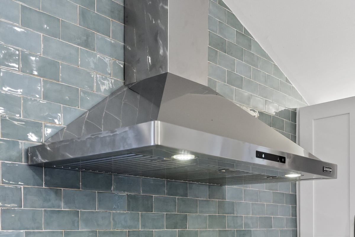 Stainless steel range hood installed in remodeled Athens, GA kitchen by Encompass Contracting