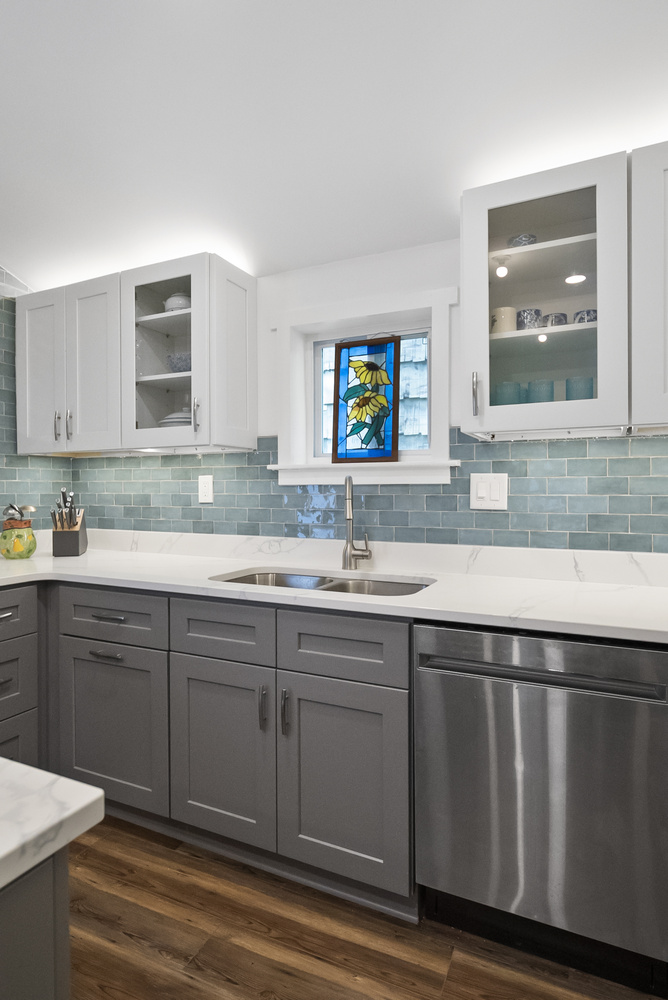 Updated kitchen remodel with quartz island and teal backsplash in Statham, GA by Encompass Contracting