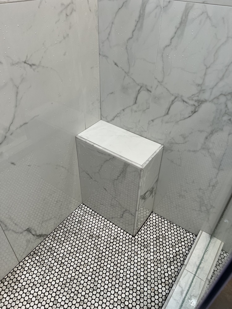 Built-in marble shower bench in Bishop bathroom remodel by Encompass Contracting