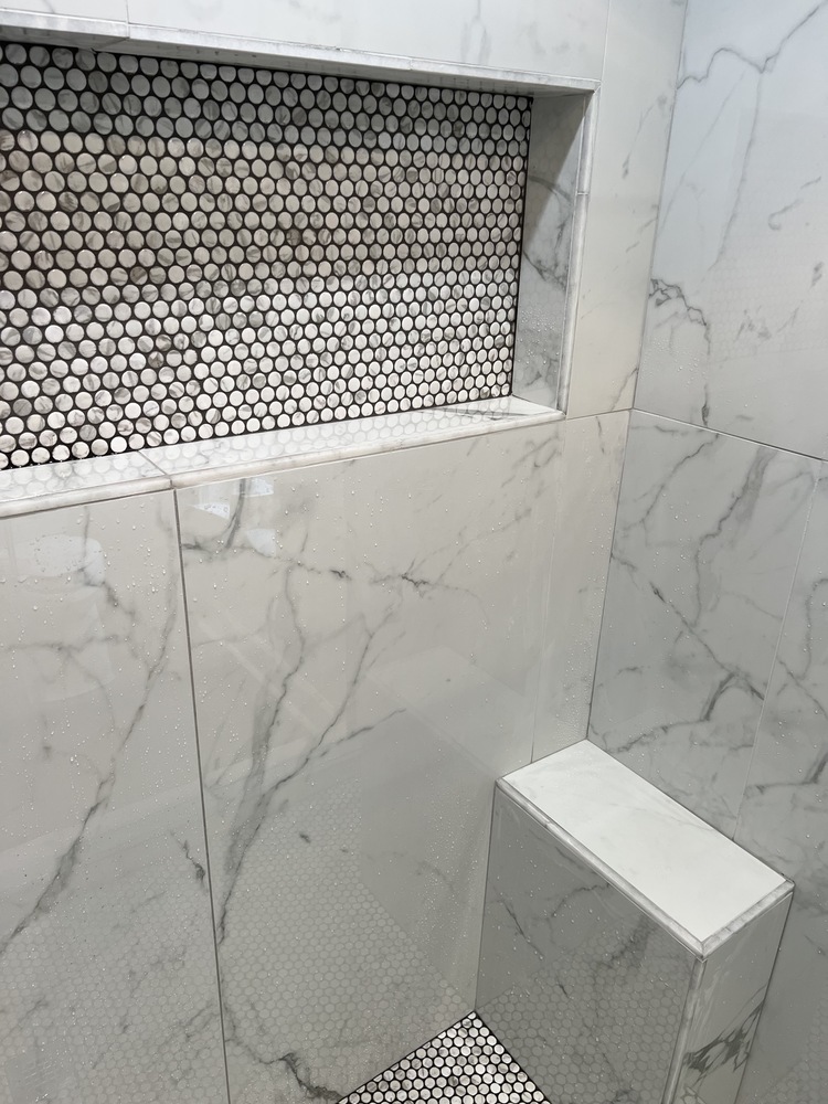Marble shower niche with mosaic tile accent in Watkinsville bathroom remodel by Encompass Contracting