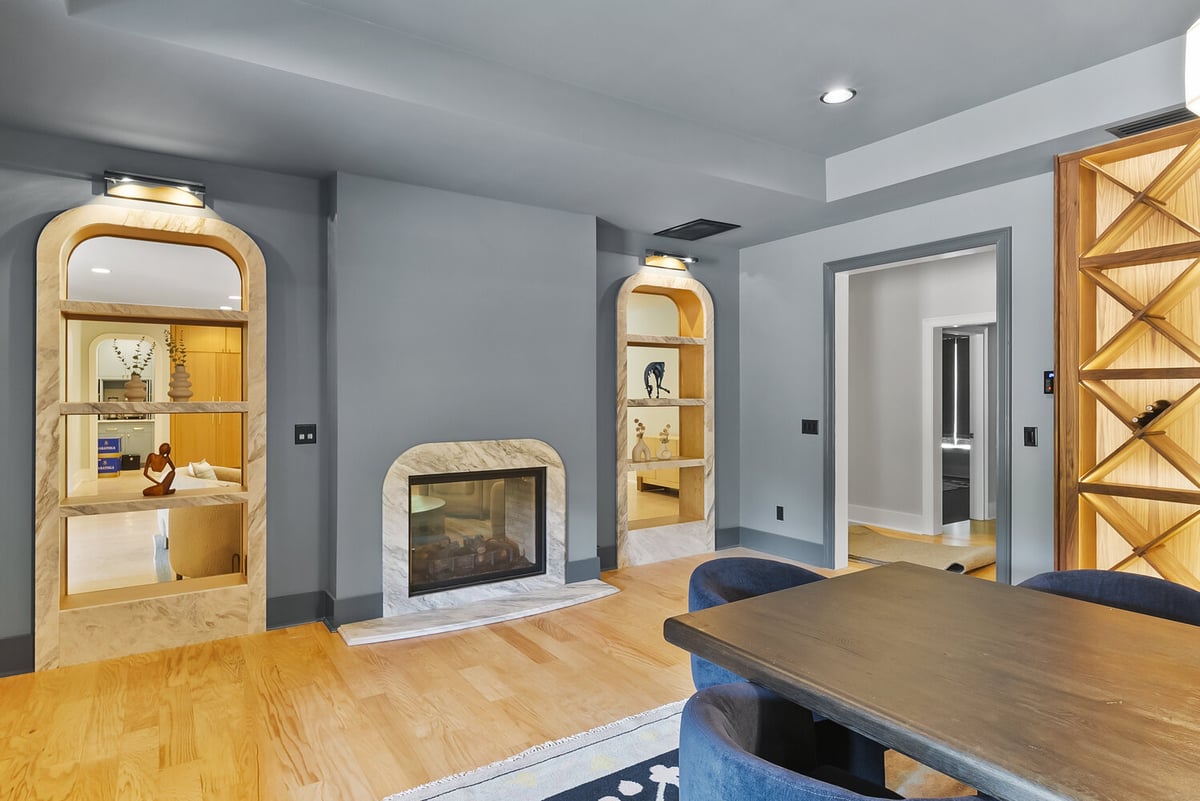 Brookhaven dining room remodel with custom fireplace and modern shelving by Encompass Contracting