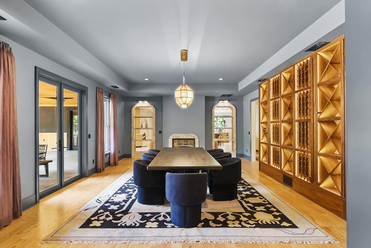 Dining room remodel with wood shelving and statement lighting in Brookhaven by Encompass Contracting