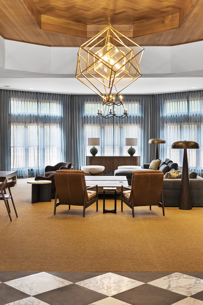 Elegant Brookhaven living room remodel with chandelier and floor-to-ceiling windows by Encompass Contracting