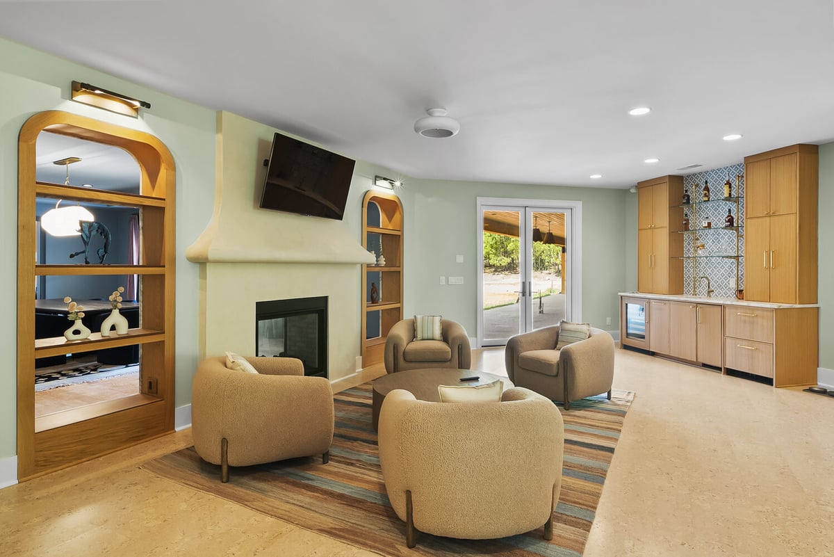 Living room remodel with fireplace and modern built-in shelving in Brookhaven by Encompass Contracting