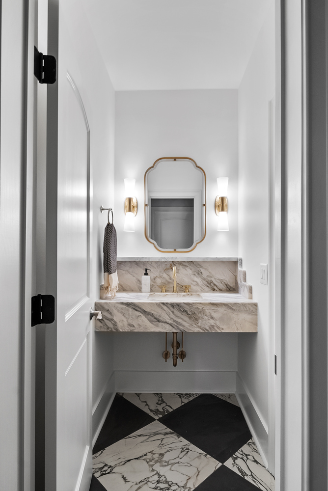 Luxury Brookhaven powder room remodel with marble vanity and gold fixtures by Encompass Contracting