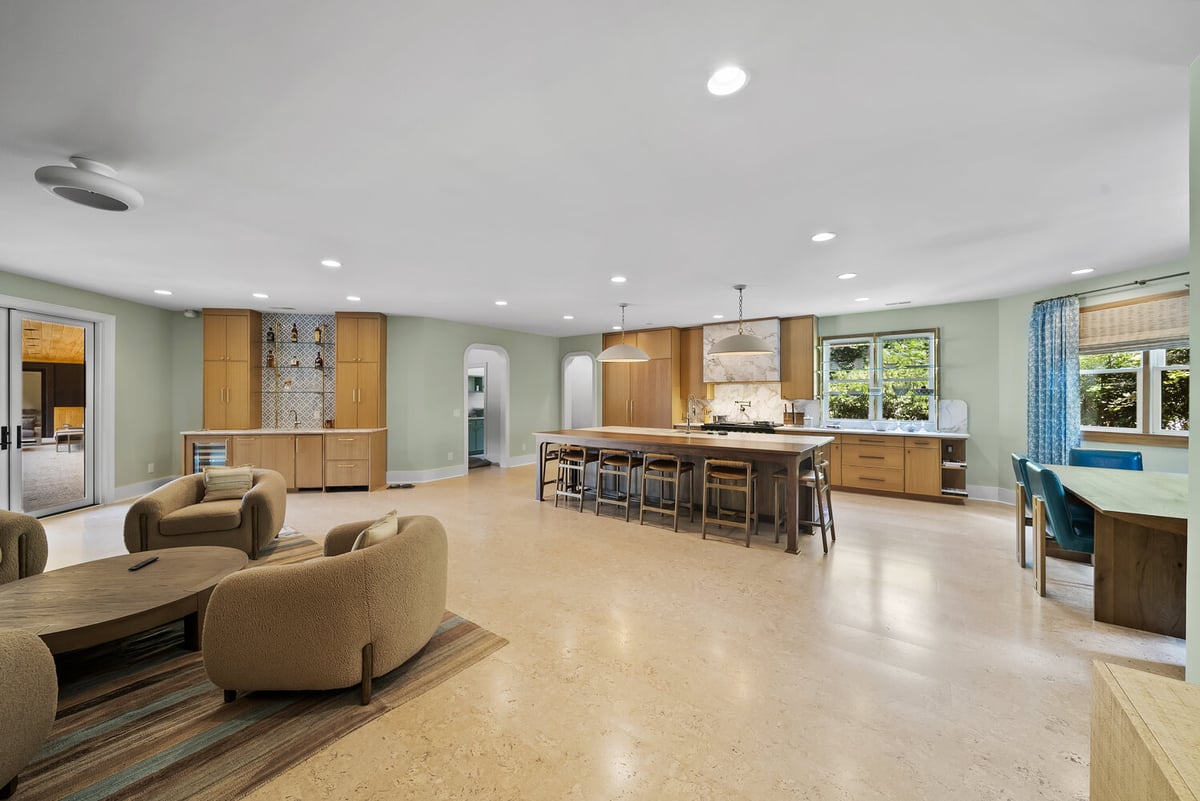 Open-concept Brookhaven kitchen remodel with large island and seating by Encompass Contracting