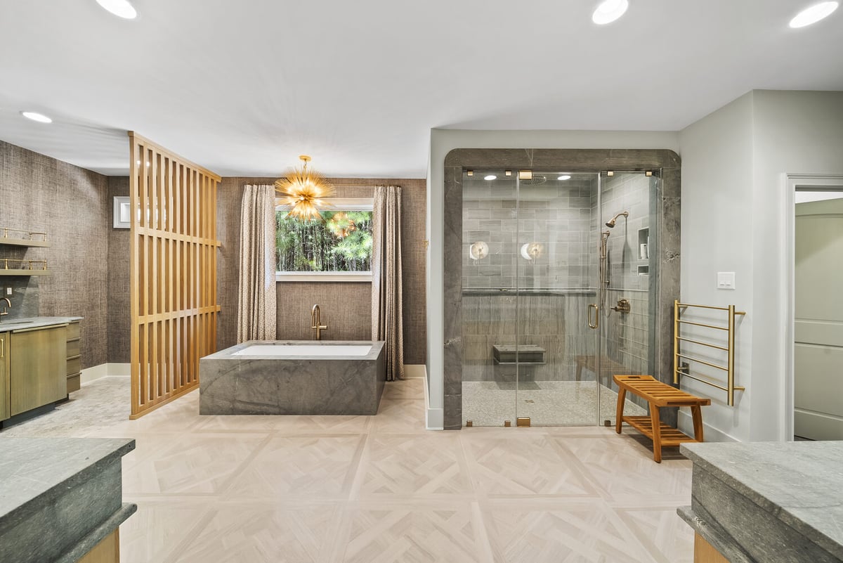 Spa-style bathroom remodel with stone tub and glass shower in Brookhaven by Encompass Contracting