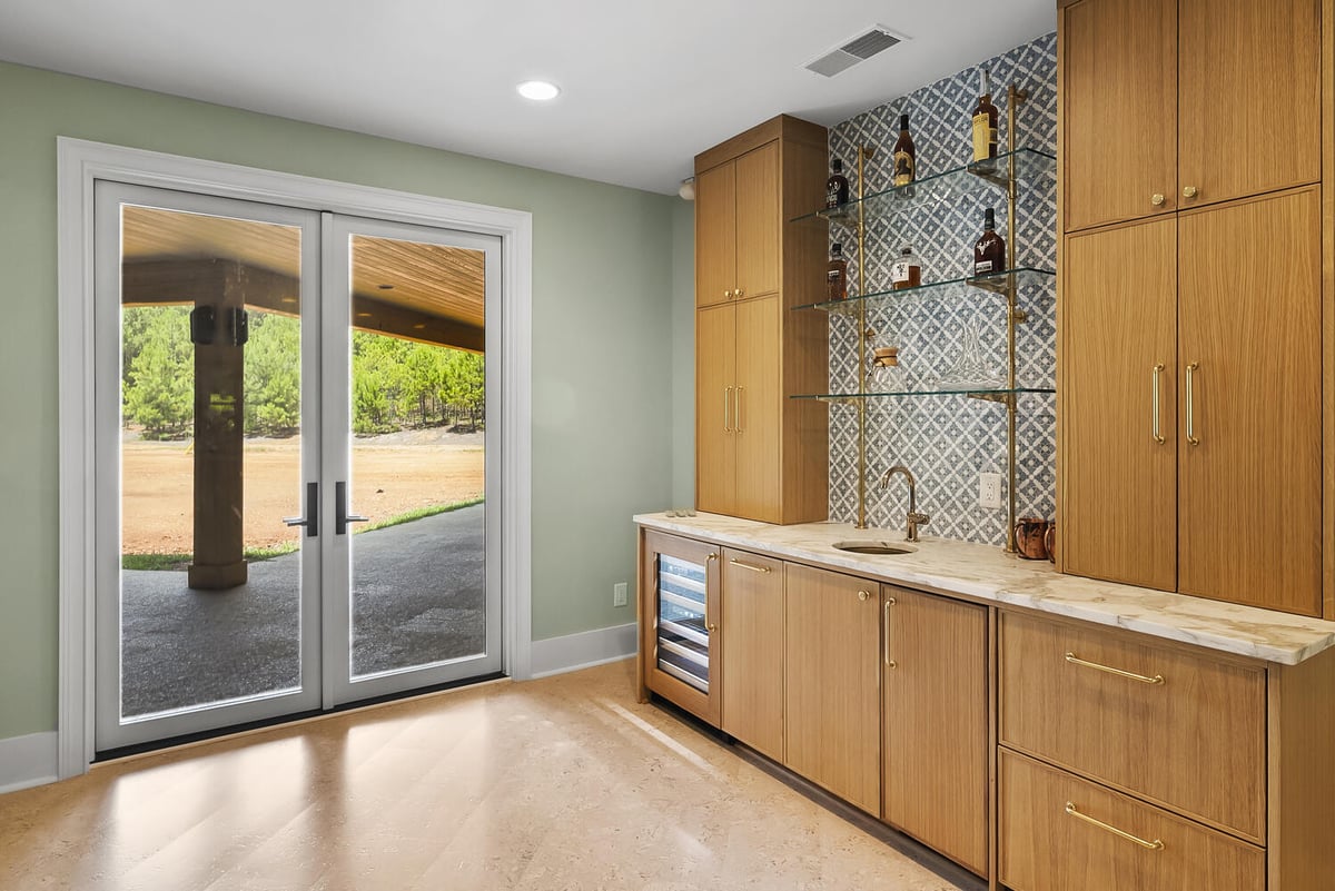 Wet bar remodel with wood cabinetry and patterned backsplash in Brookhaven by Encompass Contracting