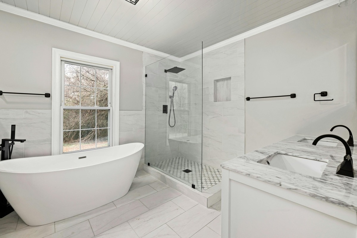 Spa-inspired bathroom remodel in Athens, GA with a soaking tub and glass shower by Encompass Contracting