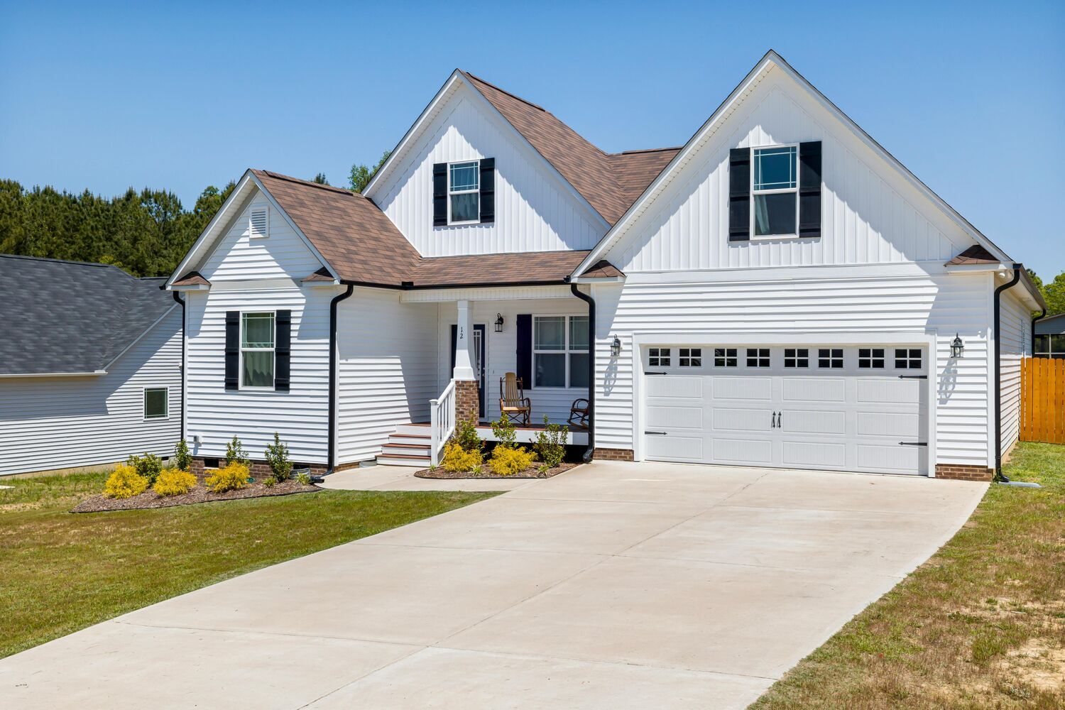Encompass Contracting built this single-story custom home in Athens, GA with clean white siding and brown roof - stock