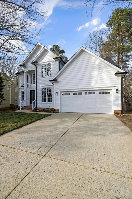 Modern white exterior home remodel in Athens, GA with fresh siding and trim by Encompass Contracting - stock