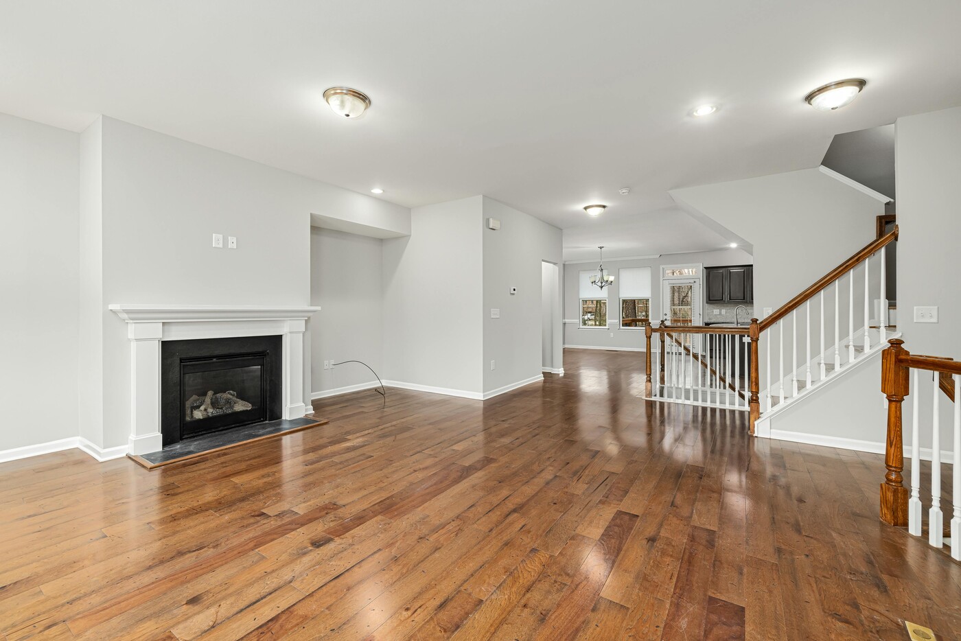 Living room remodel with a fireplace and hardwood flooring by Encompass Contracting in Athens, GA