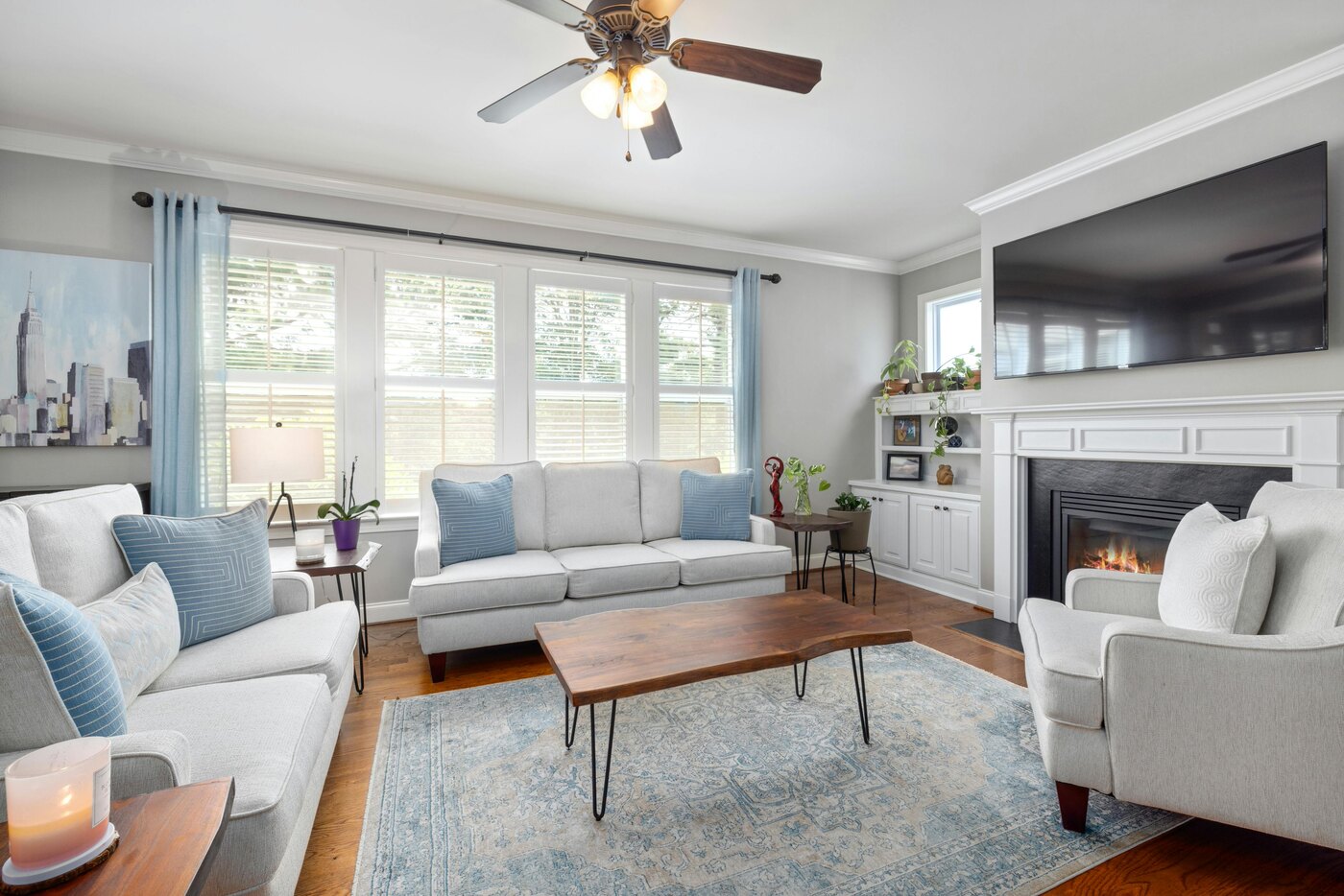 Living room remodel with fireplace and light furniture by Encompass Contracting in Athens, GA - stock