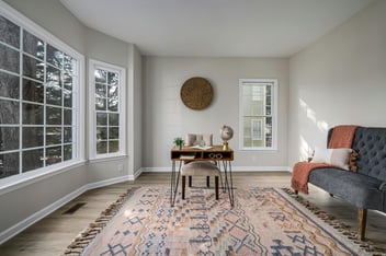 Bright home office with expansive corner windows and neutral finishes remodeled by Encompass Contracting in Athens, GA - stock