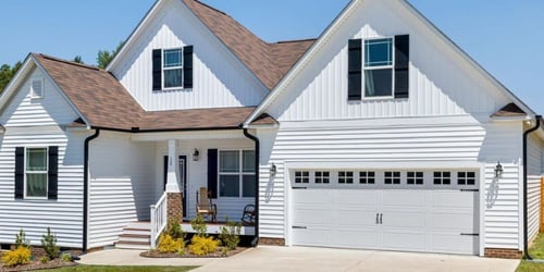 Image of a single-family home in Athens, Georgia, with white fiber cement siding and black trim. 