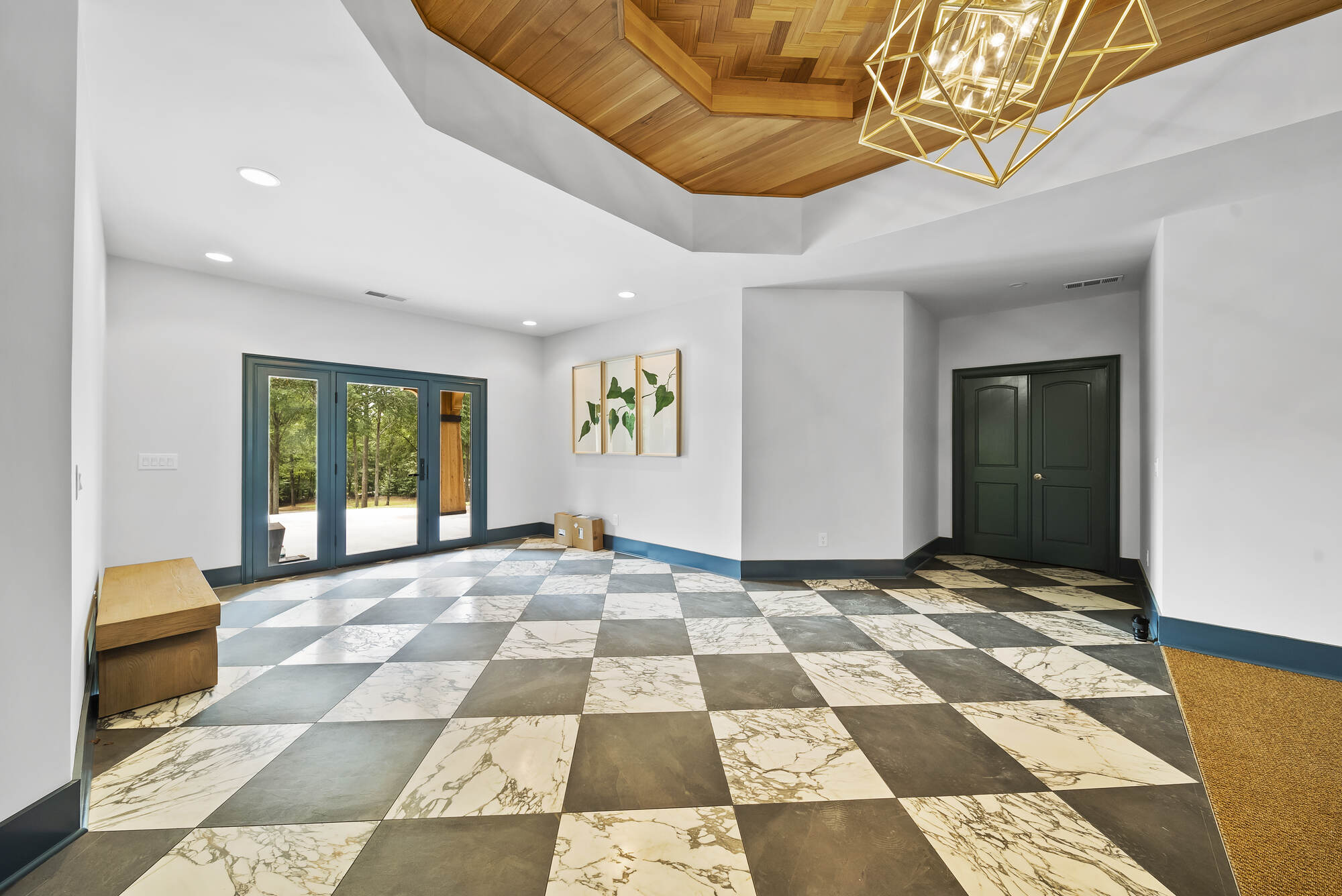 Entryway with marble tile flooring and custom ceiling in Brookhaven remodel by Encompass Contracting