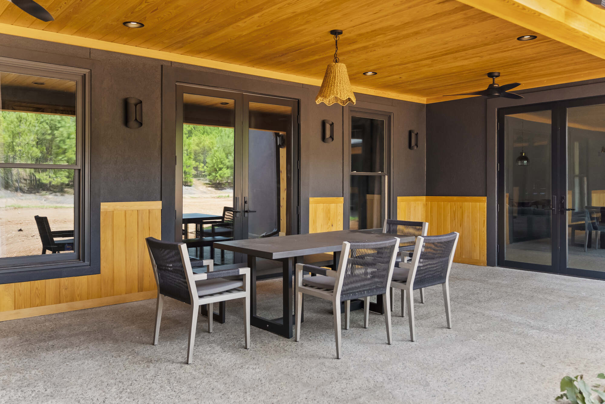 Outdoor patio dining area with wood ceiling in Brookhaven whole home remodel by Encompass Contracting