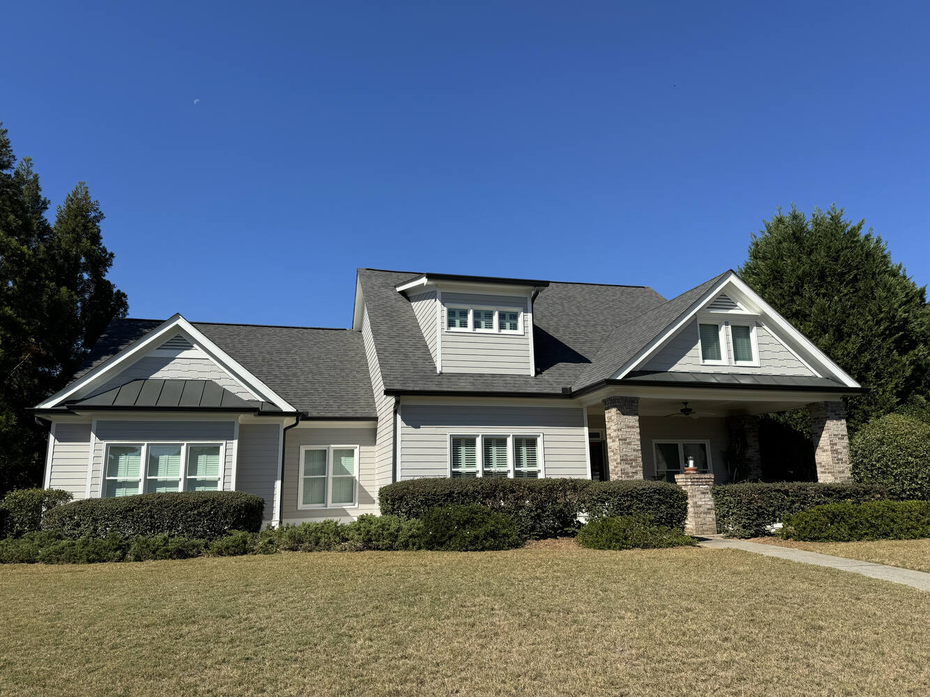 Light gray siding home exterior painting project by Encompass Contracting in Statham, GA