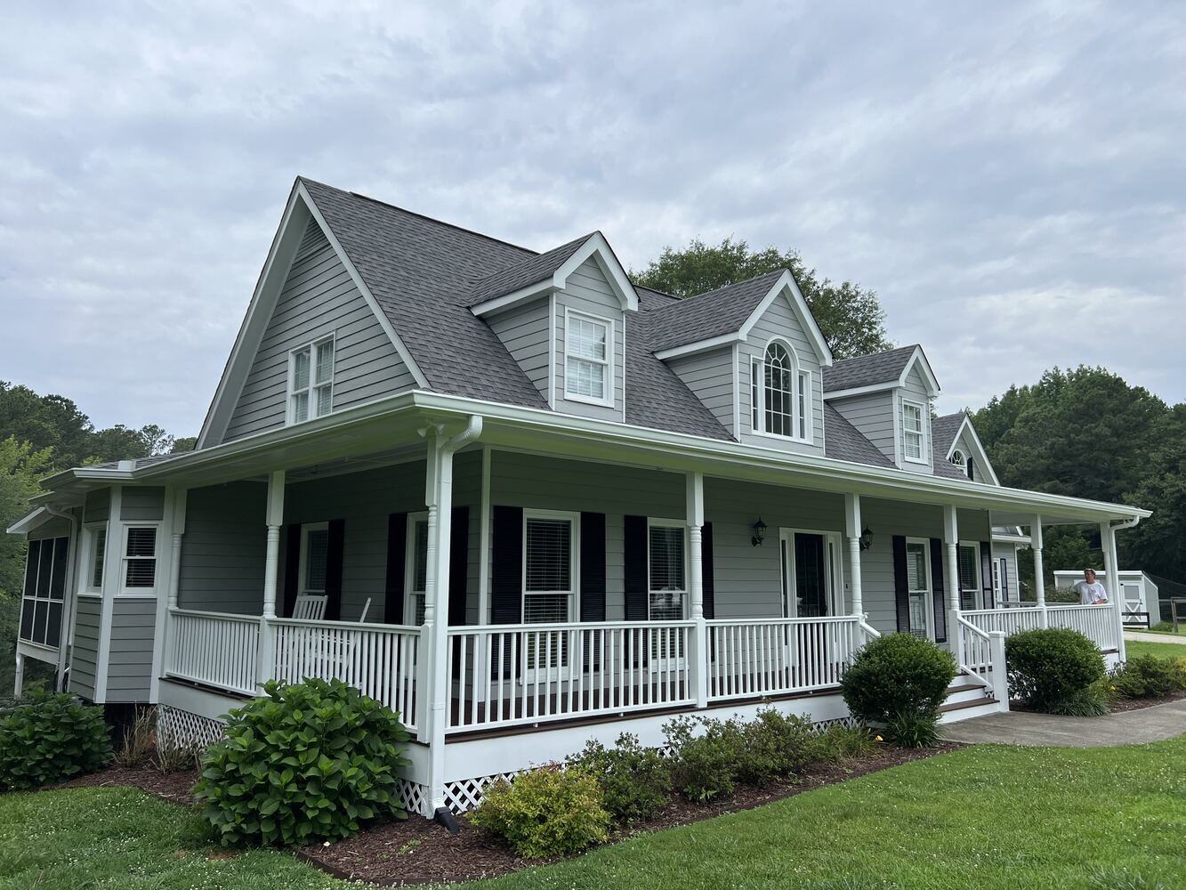 Wraparound porch home with gray exterior repaint by Encompass Contracting in Statham, GA