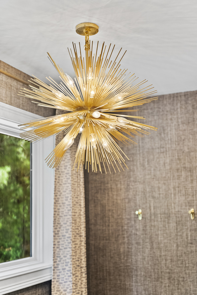 Designer gold chandelier in Brookhaven bathroom remodel by Encompass Contracting