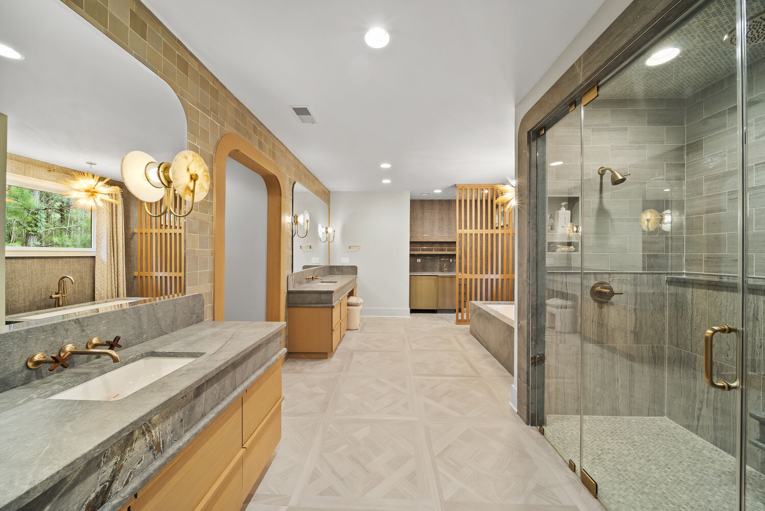 Spacious luxury bathroom remodel with double vanities and glass shower in Brookhaven by Encompass Contracting