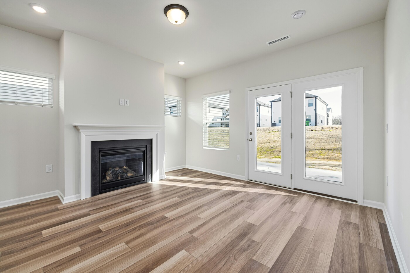 Living room remodel with fireplace and French doors by Encompass Contracting in Athens, GA - stock